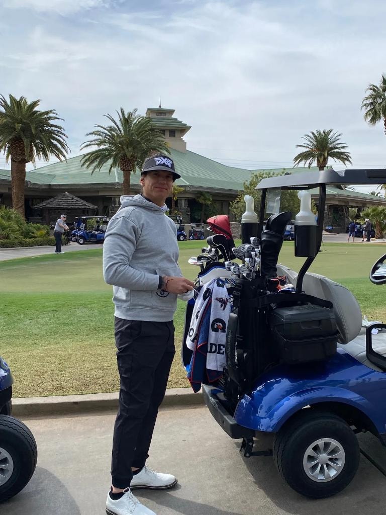Participante junto a carrito de golf